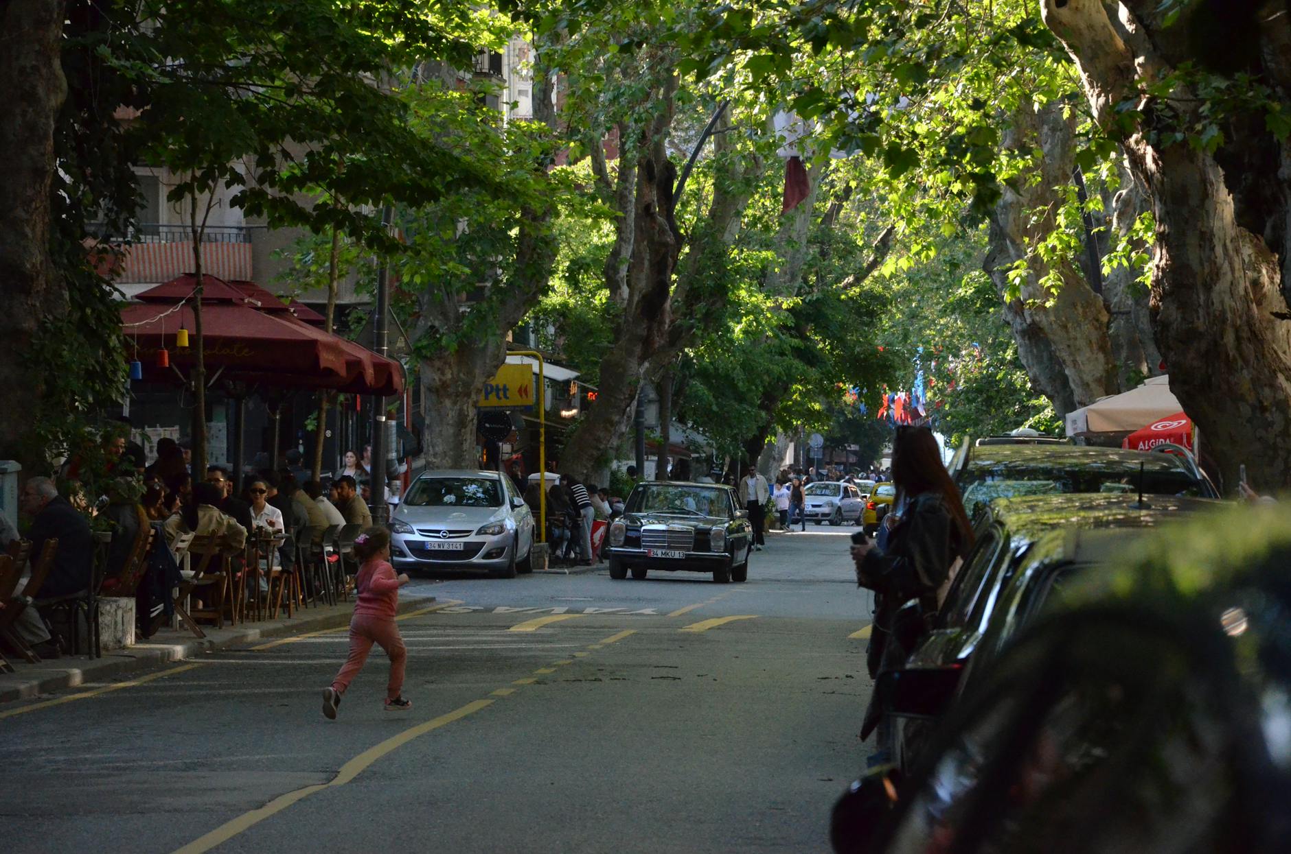 A scenic view of historic brick buildings and tree-lined streets in downtown Malden, Massachusetts, during late afternoon.
