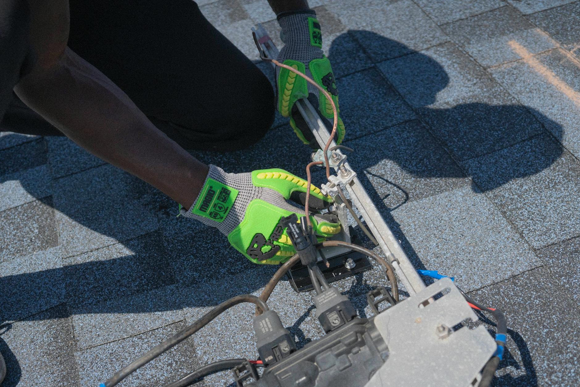 A professional roofing inspector examining shingles and chimney flashing on a residential roof in Somerville.