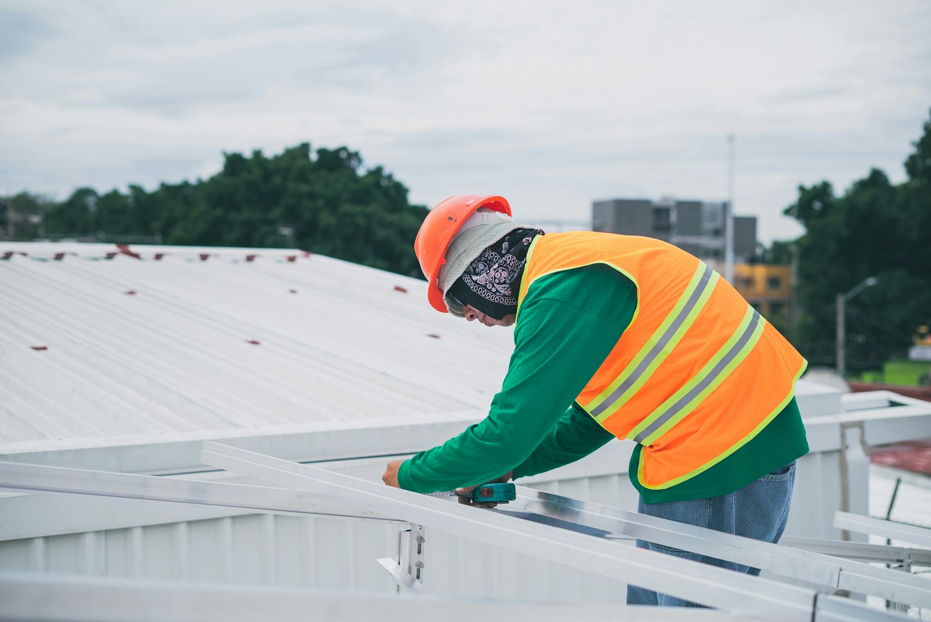 An organized roofing job site in Newton with safety equipment and high-quality shingles ready for installation