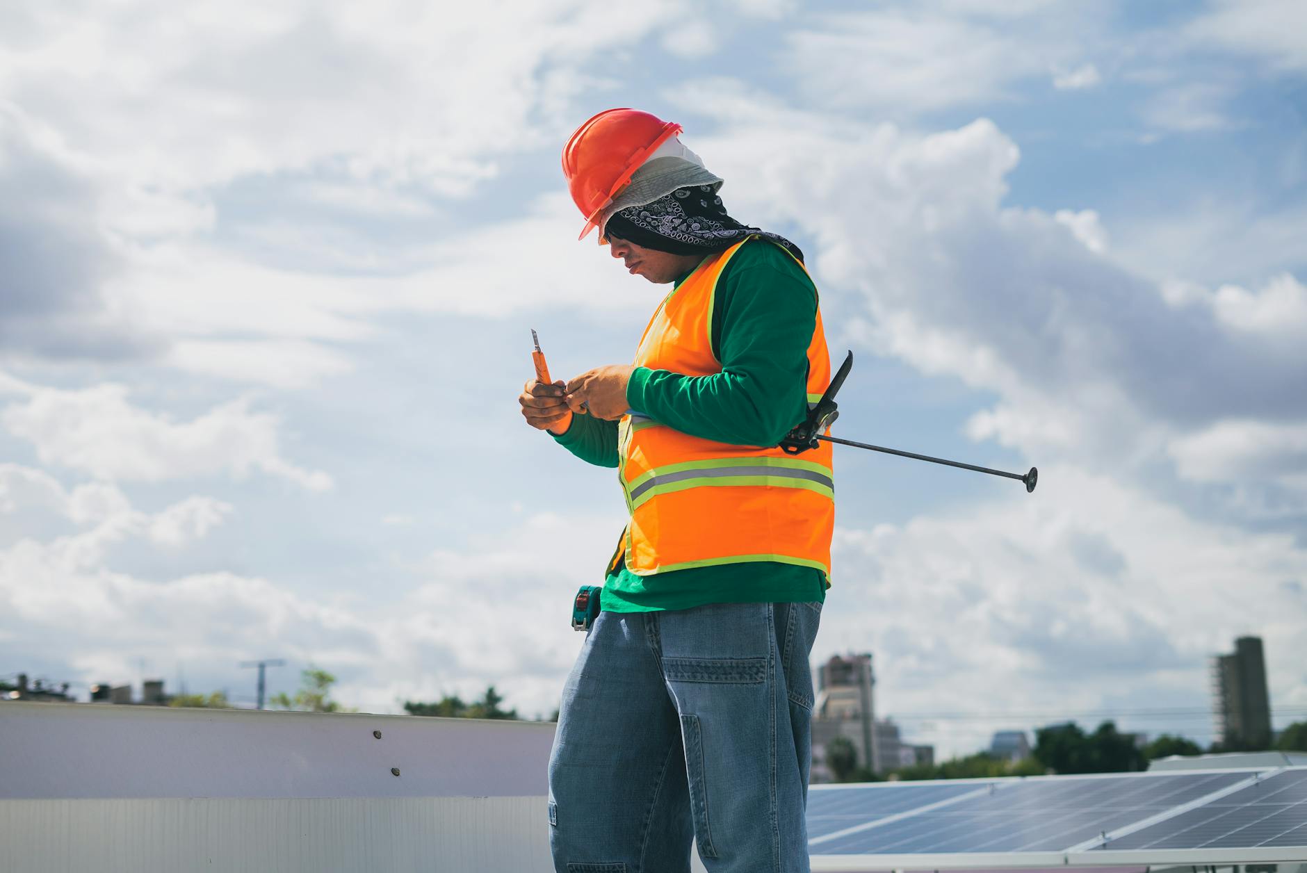 A Harbor Roofing Co technician pointing out a ventilation ridge vent detail to a homeowner in Malden, Massachusetts.